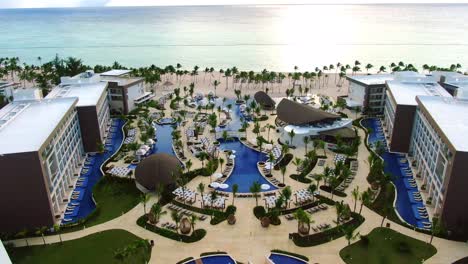 Exotic-tropical-hotel-and-beach,-luxury-travel-and-tourist-destination-in-the-Caribbean-Sea,-romantic-paradise-getaway-in-Punta-Cana,-Dominican-Republic,-aerial-view