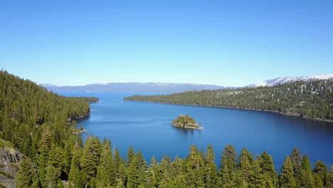 Aerial-descending,-Lake-Tahoe-Emerald-Bay-over-forest-of-trees-and-water