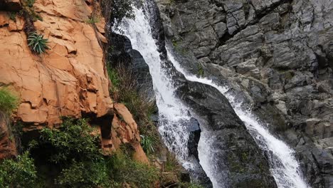 Crocodile-river-waterfall-flowing-and-falling-over-rocks-at-the-walter-sisulu-national-botanical-gardens-in-roodepoort,-South-Africa