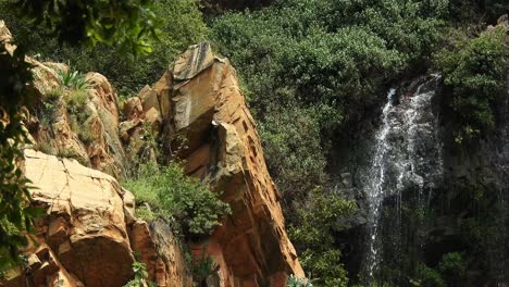 Crocodile-river-waterfall-flowing-and-falling-over-rocks-at-the-walter-sisulu-national-botanical-gardens-in-roodepoort,-South-Africa