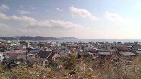 Traditional-Japanese-Houses-Along-The-Kamakura-Seaside-In-Japan---slow-motion-wide-shot