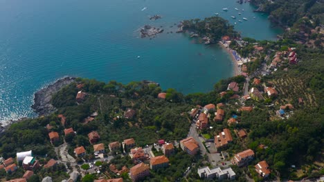 Slow-aerial,-reveal-shot-of-Italian-villages,-coast-line,-beaches-and-turquoise-waters
