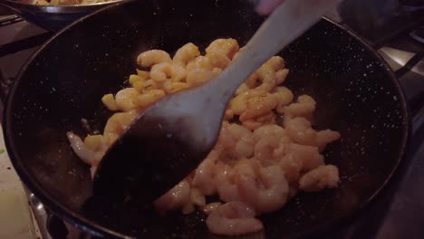 Stirring-Spanish-Garlic-Shrimp-Cooking-in-Skillet-with-Wooden-Spoon,-Close-Up