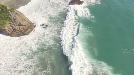 Sea-Waves-Crashing-On-The-Rocky-Shore-In-New-Zealand---Aerial-Shot