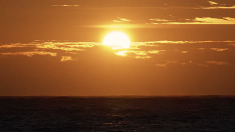 Pan-shot-of-sunrise-above-the-Skagerrak-ocean,-on-Justoya-island,-on-a-sunny-morning,-in-Aust-Agder,-Norway
