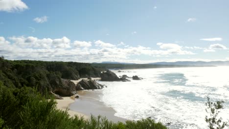 Isolated-beach-on-a-sunny-day,-view-from-headland