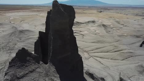 Cinematic-Aerial-View-of-Sandstone-Rock-Formation-Above-ATV-Quad-Driving-Track-in-Utah-Desert-Dry-Landscape
