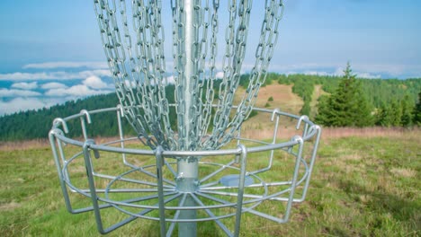 Frisbee-golf-player-reaches-in-to-retrieve-a-disc-from-the-basket