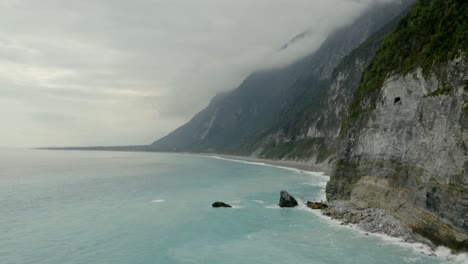 Qingshui-shoreline-cliffs-aerial-tilt-up-shot-of-Taroko-gorge-Hualien-County,-Taiwan