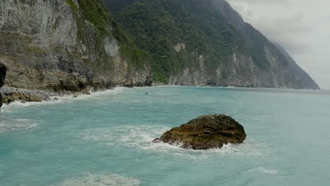 Qingshui-cliffs-scenic-low-angle-aerial-above-rocky-ocean-coastal-shoreline-of-Taroko-gorge-Hualien-County