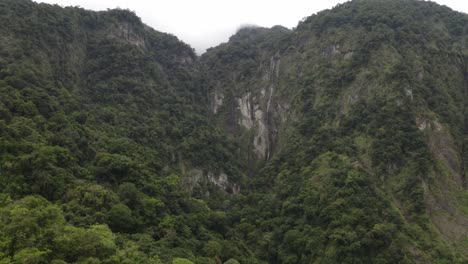 Taiwan-tropical-lush-rocky-mountain-woodland-aerial-view-to-top-summit