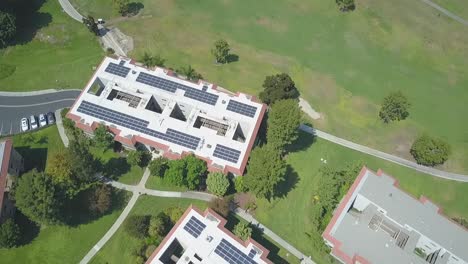 Birds-Eye-Aerial-View-of-Building-Complex-With-Solar-Panels-Renewable-Energy-Array-System,-California-USA