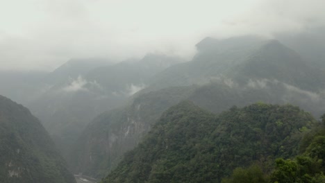 Taroko-gorge-aerial-view-above-lush-hazy-woodland-tropical-wilderness-greenery-hillsides-in-Taiwan
