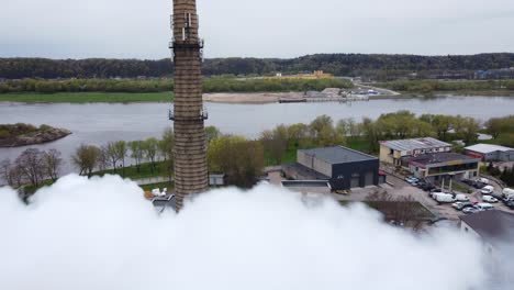 Flyby-shot-through-the-smoke-of-industrial-power-plant-chimney