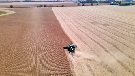 Combine-Harvester-Working-In-A-Wheat-Field-In-Wisconsin---aerial-orbit