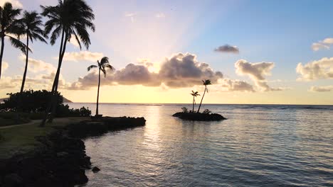 Flyby-Point-of-Interest-Palm-Tree-Island-Silhouettes,-The-ultimate-Hawaiian-experience-at-Kāhala-Beach,-Honolulu-in-2021