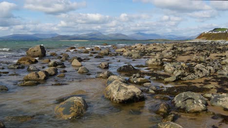 Rocky-coastline-No-7,-looking-towards-the-Llyn-Peninsula-from-near-Morfa-Dyffryn,-Wales,-UK,-Static-Camera,-20-Second-version
