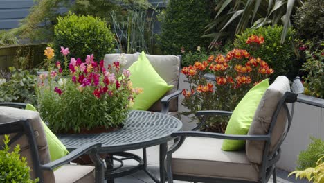 mid-shot-of-a-Mature-English-garden-with-Chairs-and-table