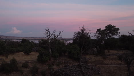 Steigende-Luftaufnahme-Des-Stausees-Santillana,-Sierra-De-Guadarrama-Während-Eines-Farbenprächtigen-Sonnenuntergangs