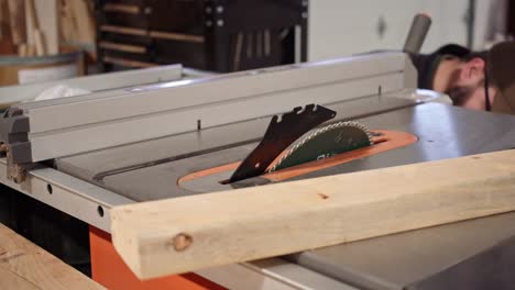 Woodworker-Adjusting-Angle-Of-A-Table-Saw-Circular-Blade-Before-Working