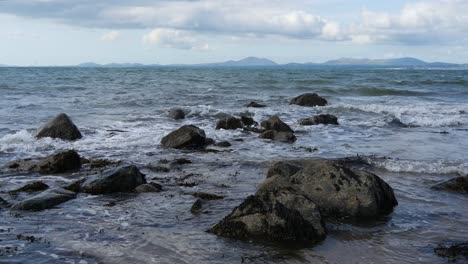 Rocky-coastline-No-2,-looking-towards-the-Llyn-Peninsula-from-near-Morfa-Dyffryn,-Wales,-UK,-Static-Camera,-20-Second-version