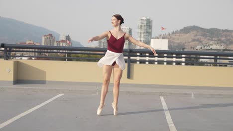 Dancing-girl-spinning-in-pointe-shoes-on-top-of-parkade