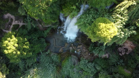 Aerial-view-of-a-beautiful-waterfall-in-the-middle-of-the-forest