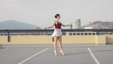 Wide-angle-of-ballet-woman-on-downtown-parkade-roof