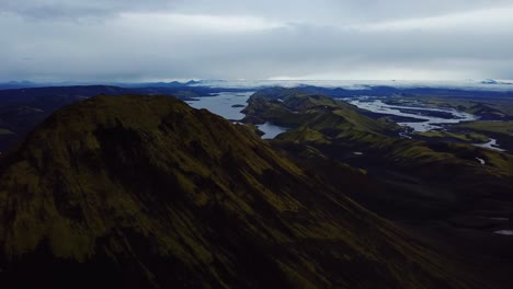 Aerial-landscape-view-of-Icelandic-highlands,-dark-mountain-peaks,-rivers-and-lakes,-on-a-moody-day