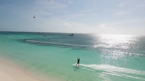 Man-silhouette-kitesurfing-on-Turquoise-sea-caribbean-beach-at-sunset