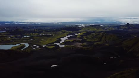 Aerial-panoramic-view-of-Icelandic-highlands,-dark-hills-and-mountains,-rivers-and-lakes,-on-a-moody-day