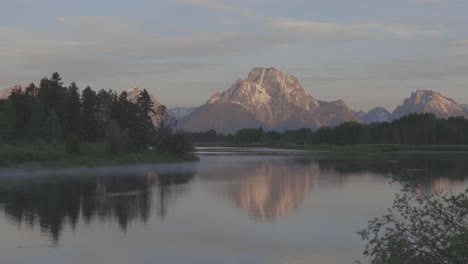 Handheld-shot-of-blazing-sunrise-light-on-Mt-Moran-in-western-Wyoming,-shot-in-4K
