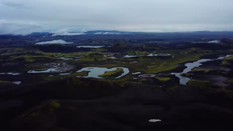Aerial-landscape-view-of-Icelandic-highlands-textures,-dark-hills-and-mountains,-rivers-and-lakes,-on-a-moody-day