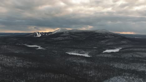 Clouded-Sky-Over-Forest-Mountains-During-Sunset-In-Winter