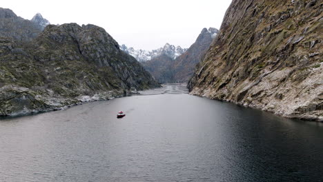 Boat-navigating-on-sea-waters-of-Trollfjord-or-Trollfjorden-fjord-in-Norway