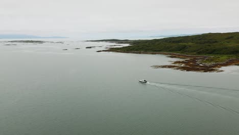 4K-Aerial-pan-around-boat-leaving-Arisaig-harbour-on-Scottish-West-Coast