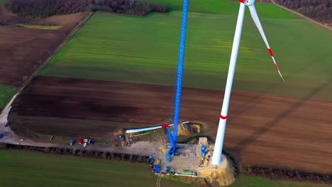 Aerial-View-Over-Wind-Turbine-Construction-Site---drone-shot