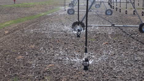 Close-up-view-of-sprinkler-pivot-at-work,-watering-crop-for-more-growth