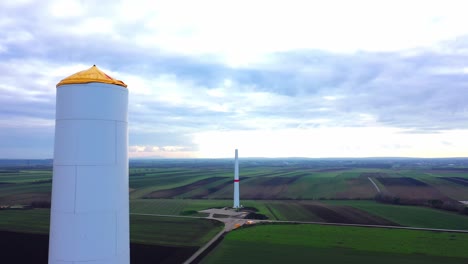 Wind-Turbines-Under-Construction-In-Idyllic-Landscape---aerial-drone-shot