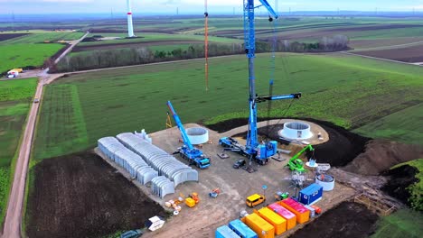 Construction-Site-Of-New-Windmill-In-A-Wind-Farm---aerial-drone-shot