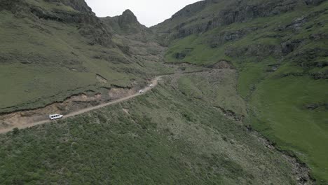 Rugged-tourist-vehicles-approach-switchbacks-on-famous-Sani-Pass-in-ZA