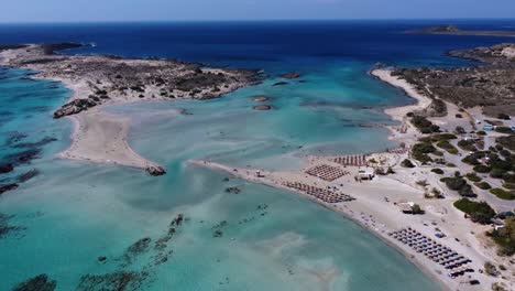 Elafonisi-beach-with-pink-sand-in-Crete-with-shallow-waters-surrounding-the-shore-with-blue-sky