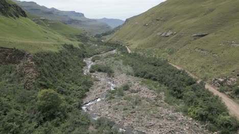 Low-aerial-over-rugged-Mkhomazana-River-in-picturesque-rocky-valley