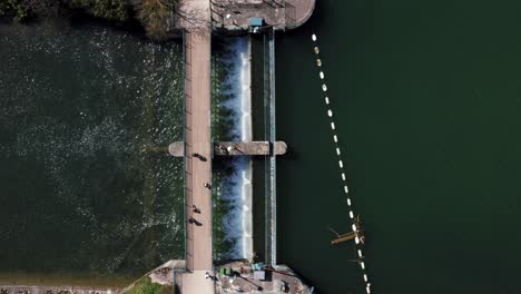 People-crossing-footbridge-over-hydro-energy