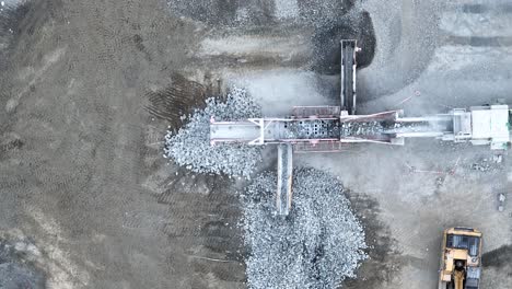 Drone-shot-of-conveyer-belt-sorting-rocks-and-rubble-into-piles-in-quarry-mine