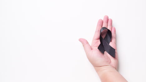 Black-awareness-ribbon-on-gray-background