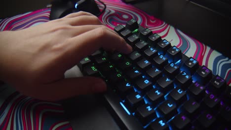 Close-up-of-hand-pressing-WASD-keys-on-keyboard,-playing-high-tension-FPS-game