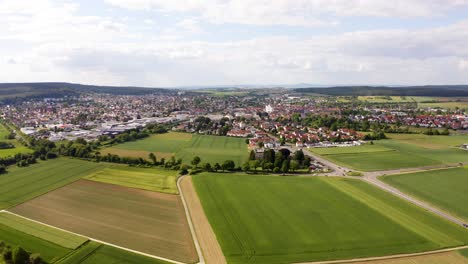 Aerial-Flying-Over-Countryside-Fields-With-View-Of-Butzbach-In-Background
