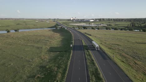 Transportation-aerial:-Commercial-trucks-deliver-cargo-along-highway