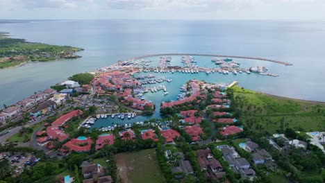 Wide-aerial-view-of-Casa-de-Campo-Marina-and-Chavón-river-mouth,-Caribbean